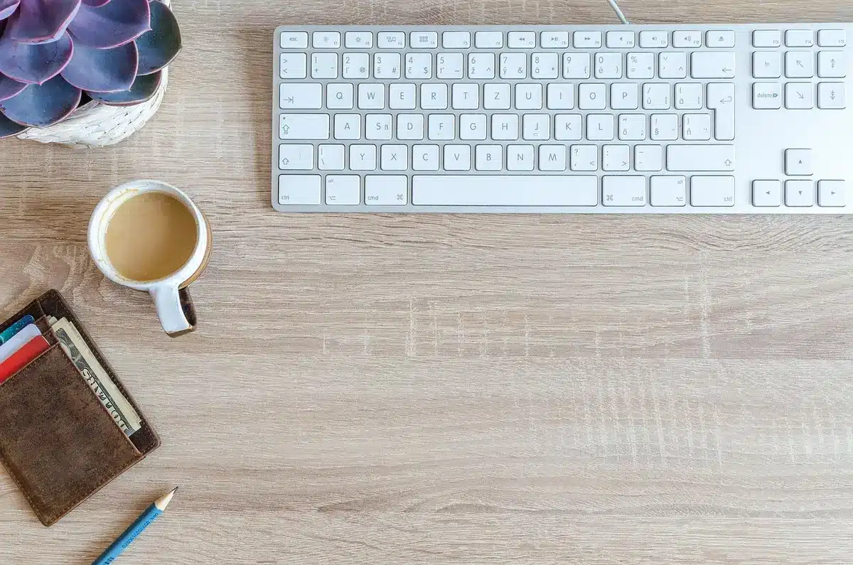 Portefeuille matériel posé sur un bureau près d'un ordinateur